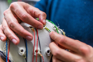Researcher adjusting electrodes on a cap
